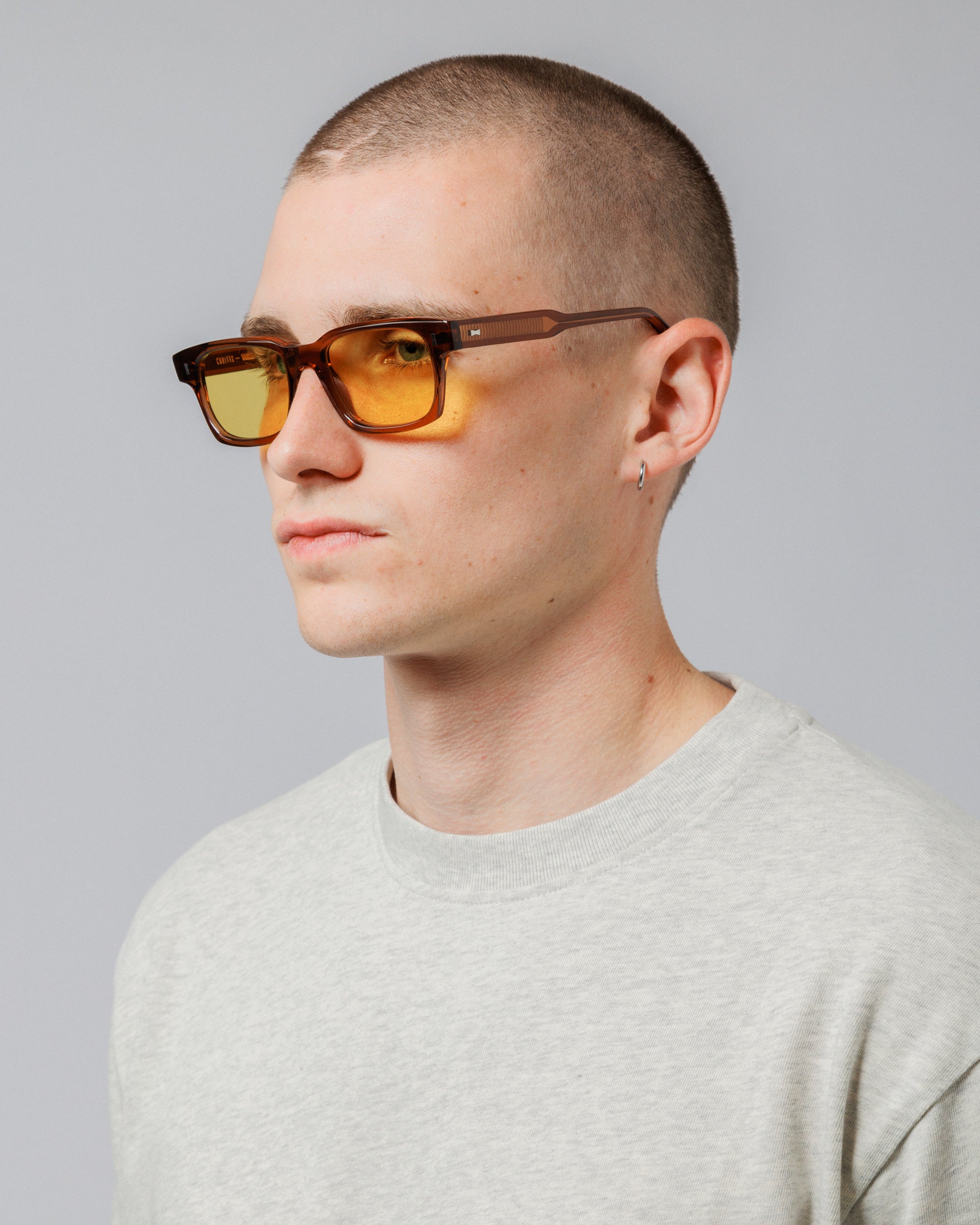 Male model wearing Solaris Sunglasses in coconut, three-quarter view